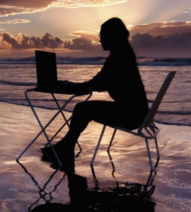 Woman-on-beach-with-laptop